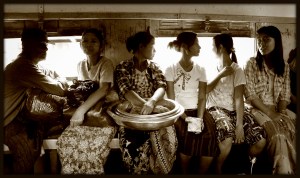 People riding on a commuter train in Yangon, Myanmar 2012